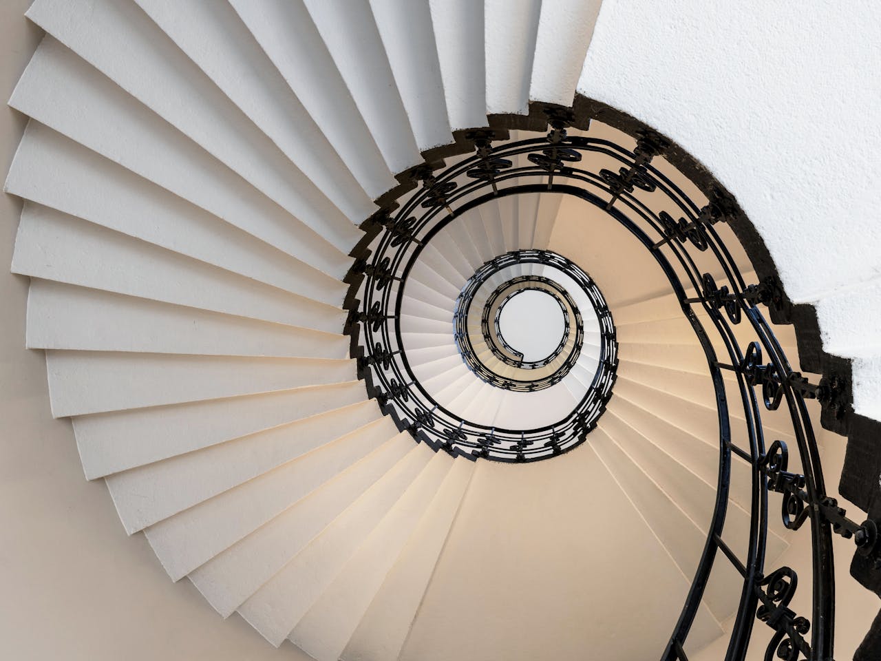 Stunning upward view of a spiral staircase in Hamburg, showcasing modern architectural elegance.